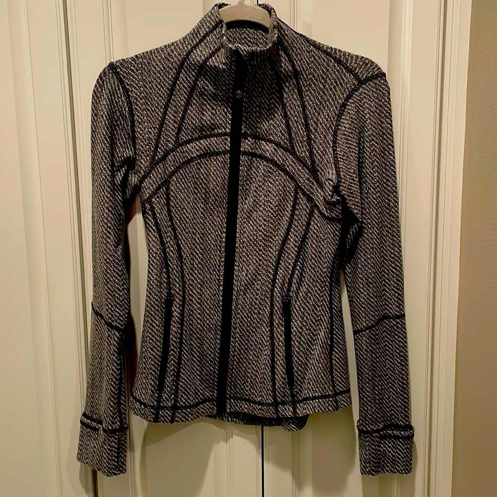 Heathered grey and white zip up jacket with black trim
